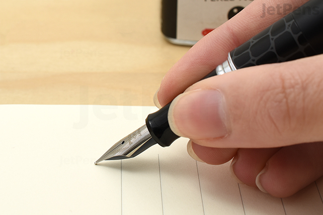 Grasp the grip section above the nib with your fingers. Do your best to hold your pen in a relaxed position.