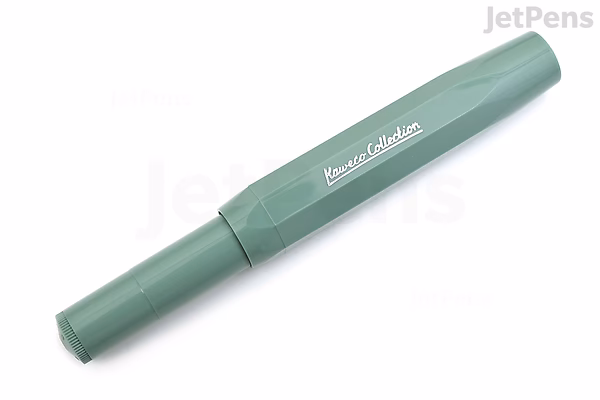 Image of a Kaweco Collection Sport Fountain Pen in a smooth sage green color with a broad nib. The pen has a compact, hexagonal design and a matte finish. The brand name "Kaweco Collection" is printed in white on the cap.