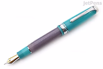 A Sailor Pro Gear fountain pen with a turquoise cap and grip section, a purple barrel, and a gold and silver nib. The pen is a limited edition "Follow the Mermaid" model with a 21k medium nib.