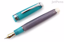 A Sailor Pro Gear fountain pen with the cap removed and placed beside it. The pen features a teal cap with silver accents and a dark purple barrel with a subtle shimmer. The nib is gold-colored and finely pointed.