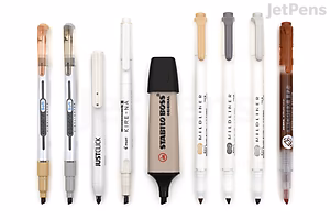 A set of eight neutral-colored highlighters and pens arranged in a row on a white background. The colors range from light beige, white, and gray to black and brown, featuring various pen designs and tip styles.