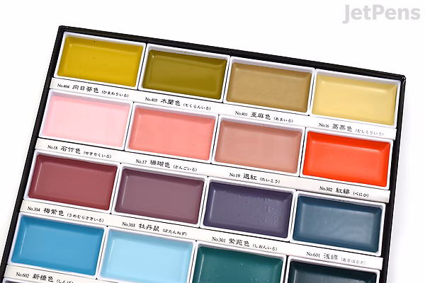 Kuretake Gansai Tambi 24-color watercolor palette featuring a range of vibrant and muted shades arranged in a compact rectangular case with Japanese labeling above each color.