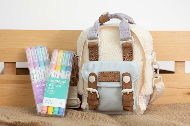 Offer: Get a free four color set of Monami Essenti Twin Highlighters with a $60.00 purchase that includes a Doughnut Fanny Pack, Macaroon Backpack, or Macaroon Tiny Crossbody Bag