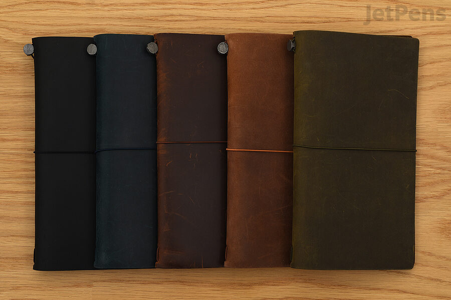 Regular TRAVELER’S notebooks, from left to right: Black, Blue, Brown, Camel, and Olive.