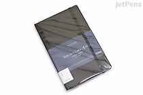 A black KOKUYO PERPANEP Premium Notebook with a 4 mm dot grid, wrapped in plastic packaging and labeled with a blue and white paper band. The notebook is rectangular and appears new.