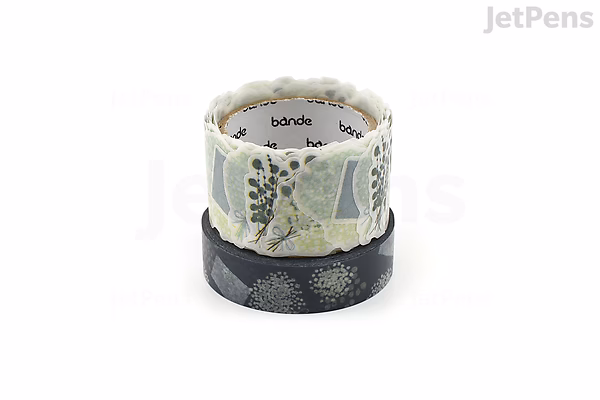 Two rolls of Bande washi tape stacked vertically. The top roll features a delicate floral design with gypsophila flowers and leaves in soft pastel colors. The bottom roll has a darker background with a subtle pattern of small flowers.