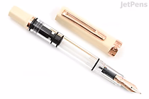 A TWSBI ECO Crème fountain pen with rose gold accents, featuring a transparent barrel and a fine nib. The pen cap is removed and placed beside the pen.