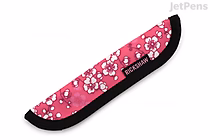 A long, slim pen sleeve with a bright pink background featuring a pattern of white and light pink sakura (cherry blossom) flowers. The sleeve has a black trim along the edges and a small black label with white text near the opening.