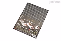 A Kyoei Orions Kiwami Shitajiki writing board in B5+ size with a black grid design. The board is rectangular and has a label on the bottom left corner showing product details and usage examples. The grid pattern covers the entire surface.