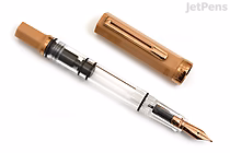 A TWSBI ECO Caffè Bronze Limited Edition fountain pen with a fine nib, shown uncapped. The pen features a transparent barrel and a bronze-colored cap and nib. The cap is placed beside the pen on a white background.