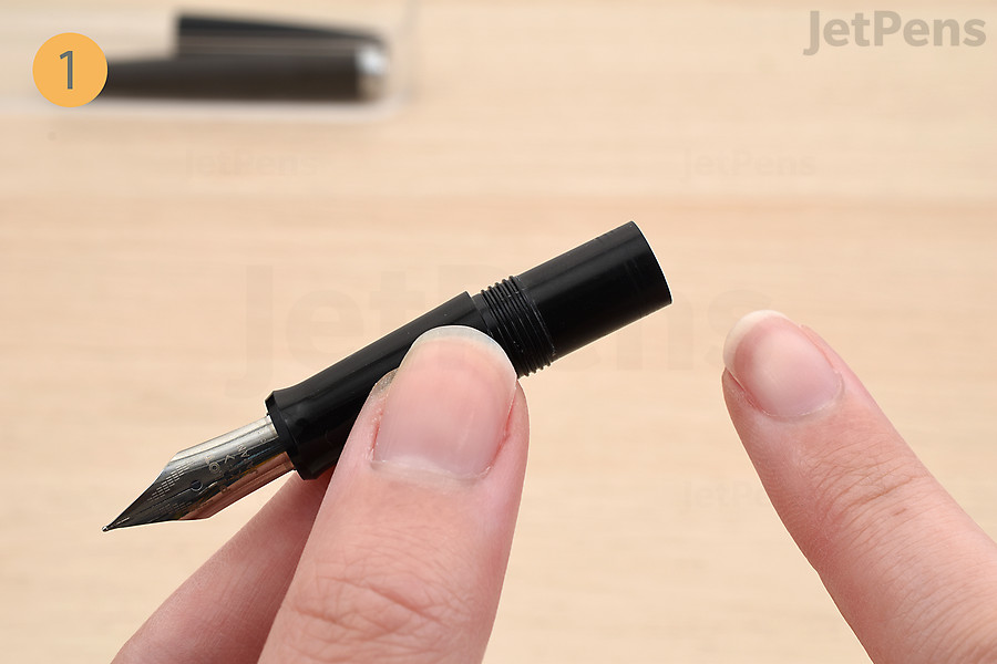 Uncap the pen and unscrew the grip section.