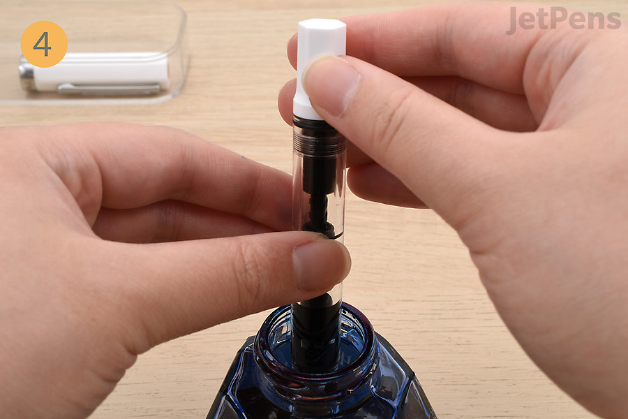 Twist the piston knob in the opposite direction to retract the piston and fill the ink reservoir.