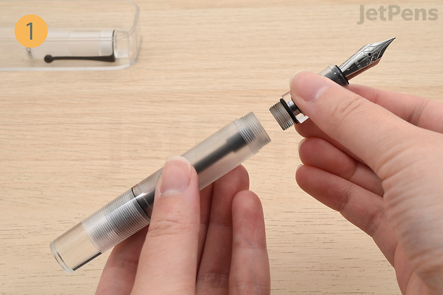 Uncap the pen and unscrew the grip section.