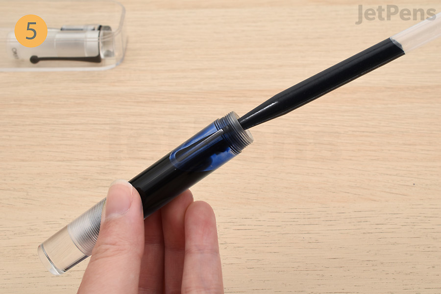 Fill the barrel with ink up to the bottom of the inside threads.