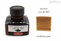 A 30 ml bottle of Herbin Lie de Thé (Tea Brown) ink with a black cap and a white label featuring red and black text. Next to the bottle is a swatch of the ink color, showing a warm, medium brown shade. The text "Herbin Lie de Thé" and "JetPens.com" appear