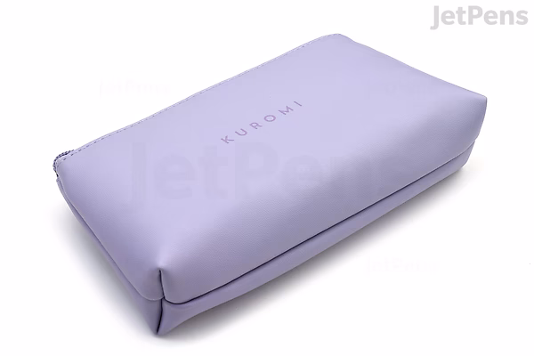 A rectangular lavender-colored pen case with a smooth, slightly shiny surface. The word "KUROMI" is printed in small, simple letters on the top center. The case has a zipper running along one edge.