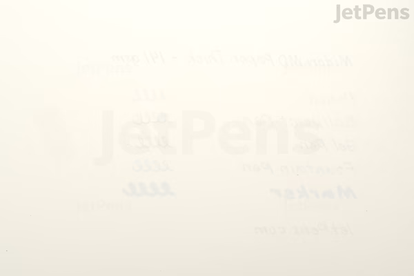 A close-up view of an open Midori MD Notebook Thick in A5 Square size, showing blank, off-white pages with a subtle grid pattern. The paper appears smooth and slightly textured, designed for writing or drawing.