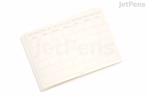 A stack of undated monthly calendar sticker sheets in medium landscape format with a simple grid layout, designed for customizable use.