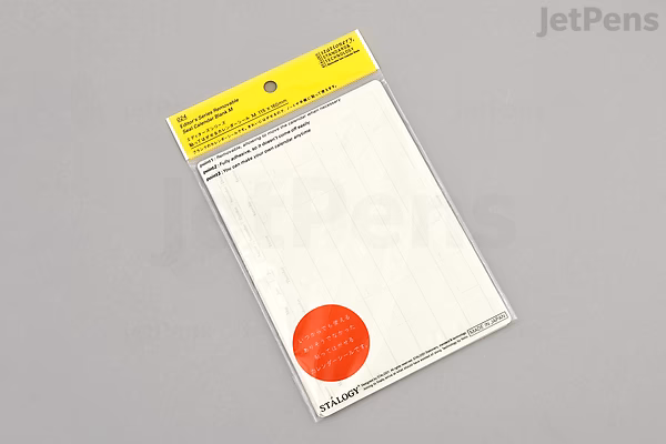 Package of STALOGY Removable Calendar Stickers, undated monthly format, medium landscape size. The pack is mostly white with a yellow header and a red circular label on the front, displayed on a gray background.