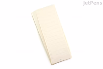 A small stack of rectangular, cream-colored removable stickers with horizontal lines and checkboxes on the left side, designed for making to-do lists.