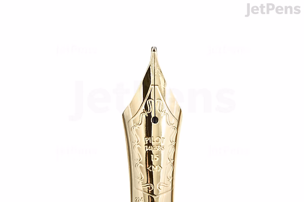 Close-up image of a gold-colored fountain pen nib with intricate engravings, including the brand name "Pilot" and "14K" indicating the gold content.