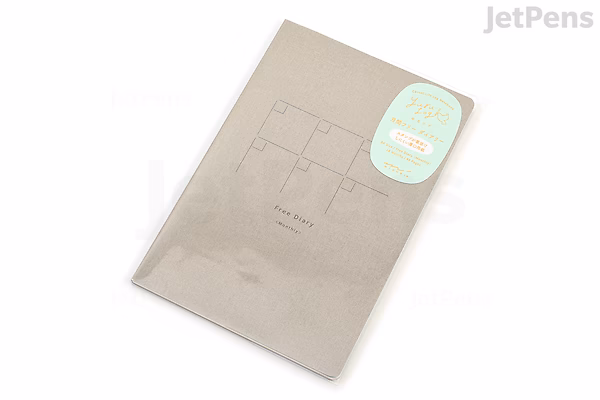Midori Yuru Log Notebook in B6 size with a gray cover, featuring a thick MD paper and a free monthly diary inside. The notebook is designed for easy, casual logging and planning.