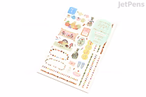 Two sheets of colorful, decorative removable stickers featuring various everyday items, food, and cute character illustrations, with text labels and small decorative elements.