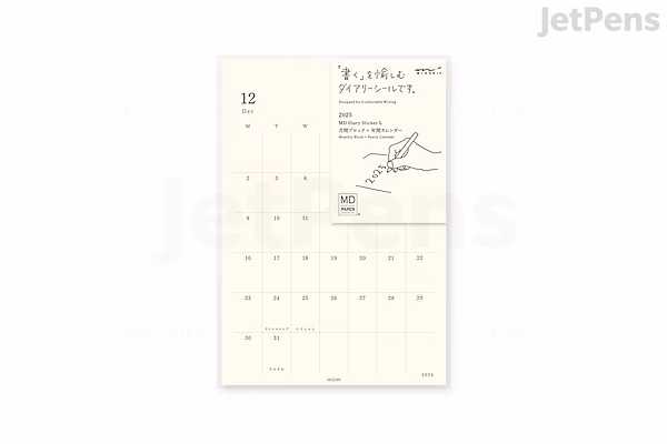 A sheet of Midori MD Diary 2025 stickers in a large size, featuring a minimalist calendar layout with dates and small decorative elements on a cream-colored background.