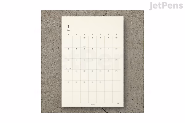 A sheet of Midori MD Diary 2025 stickers featuring a simple, minimalist calendar layout with numbered days arranged in a grid for organizing dates. The stickers are off-white with subtle, light gray lines and numbers.