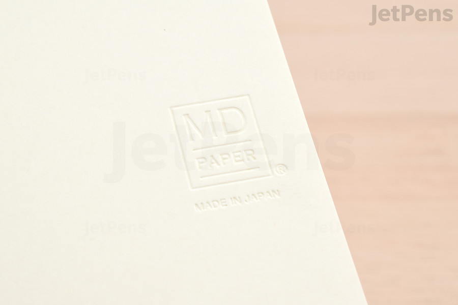 A blind-embossed logo on the front cover is the only marking on the outside.