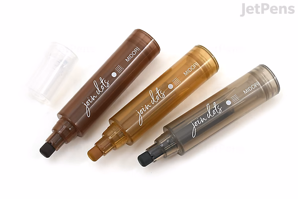 Three Midori Join Dots Connecting Markers in mocha color set, arranged diagonally on a white background with one marker cap removed, showing the fine tip.
