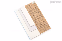 A set of translucent paper samples arranged in a fan shape on a white background, with a brown information card labeled "Yamamoto Paper Tasting - Translucent Vol. 2" placed on top. The papers vary in opacity and texture.