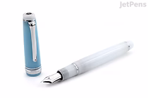 Sailor Pro Gear Fountain Pen with 21k extra fine nib, part of the limited edition Sapporo Snow Festival series, shown uncapped with cap standing beside it on a white background.