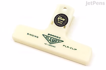 A pale yellow Penco Plastic Clampy Clip with "Glow" printed on it, designed for holding papers together. The clip has a wide, flat gripping surface and a hole at the top for hanging.