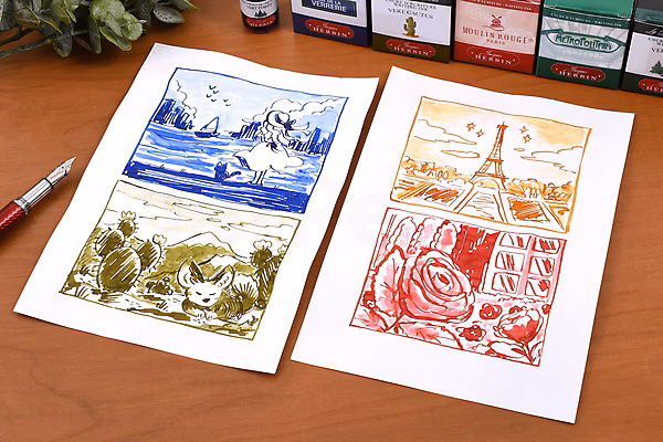 Two sheets of paper with detailed ink sketches in blue, green, orange, and red, placed on a wooden desk next to a pen and a box of Herbin Ambre de Birmanie ink bottles.