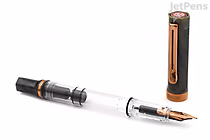 A TWSBI ECO Serpentine fountain pen with a bronze-colored nib and accents, shown uncapped with the cap standing upright beside it. The pen body is transparent, revealing the internal ink reservoir, and the nib is labeled extra fine.