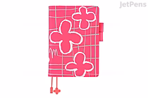 Hobonichi Techo Cousin A5 planner and cover (2026 Jan start) in bright pink with white outlined stylized flowers, grid pattern, strap closure and two dangling bead bookmarks.