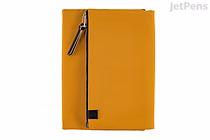 Mustard Hobonichi Techo Cousin A5 English planner with matching cover, diagonal zippered pocket and pen loop on spine — 2026 January start.