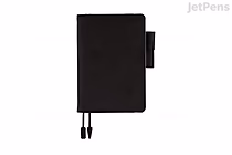 Black Hobonichi Techo Original A6 planner with black cover, pen loop at right and two ribbon bookmarks tipped with clear blue tabs. 2026 January start, English edition.