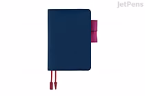 A6 Hobonichi Techo Original 2026 planner in Mystic Berry: dark navy cover with magenta pen loop and two matching magenta ribbon bookmarks.