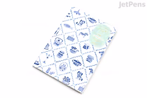 B6 Midori Yuru Log notebook with cream MD paper (5 mm dotted). White cover printed with blue Nordic-style motifs in a diamond grid and a pale green circular accent.