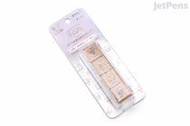 Packaged Midori "Yuru Log" pre-inked paintable stamp set on lavender backing card, four small square stamps showing simple daily-life icons and doodle frames.