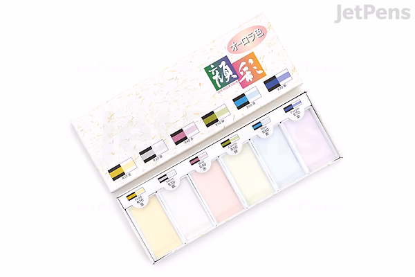 Top-down photo of a Boku-Undo Gansai Aurora 6-color watercolor palette in a white case with six pastel pans and small mixing wells.