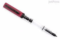 TWSBI ECO fountain pen with plum cap and clear demonstrator barrel, black onyx piston mechanism and black medium nib, shown angled on a white background.