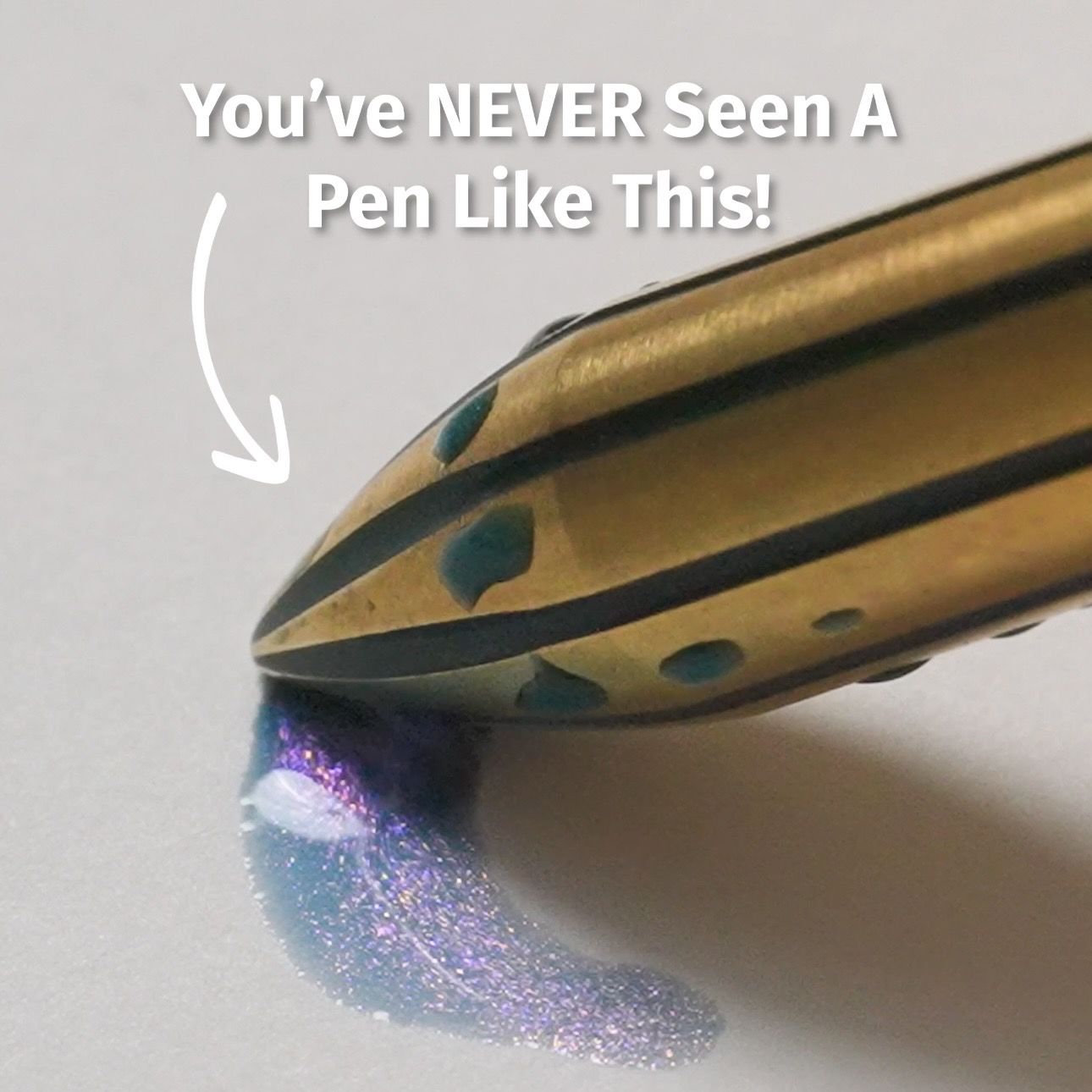 Close-up of a gold metallic pen tip dispensing iridescent purple-blue glitter onto white paper; overlaid text reads "You've NEVER SEEN A Pen Like This!" with an arrow pointing to the tip.