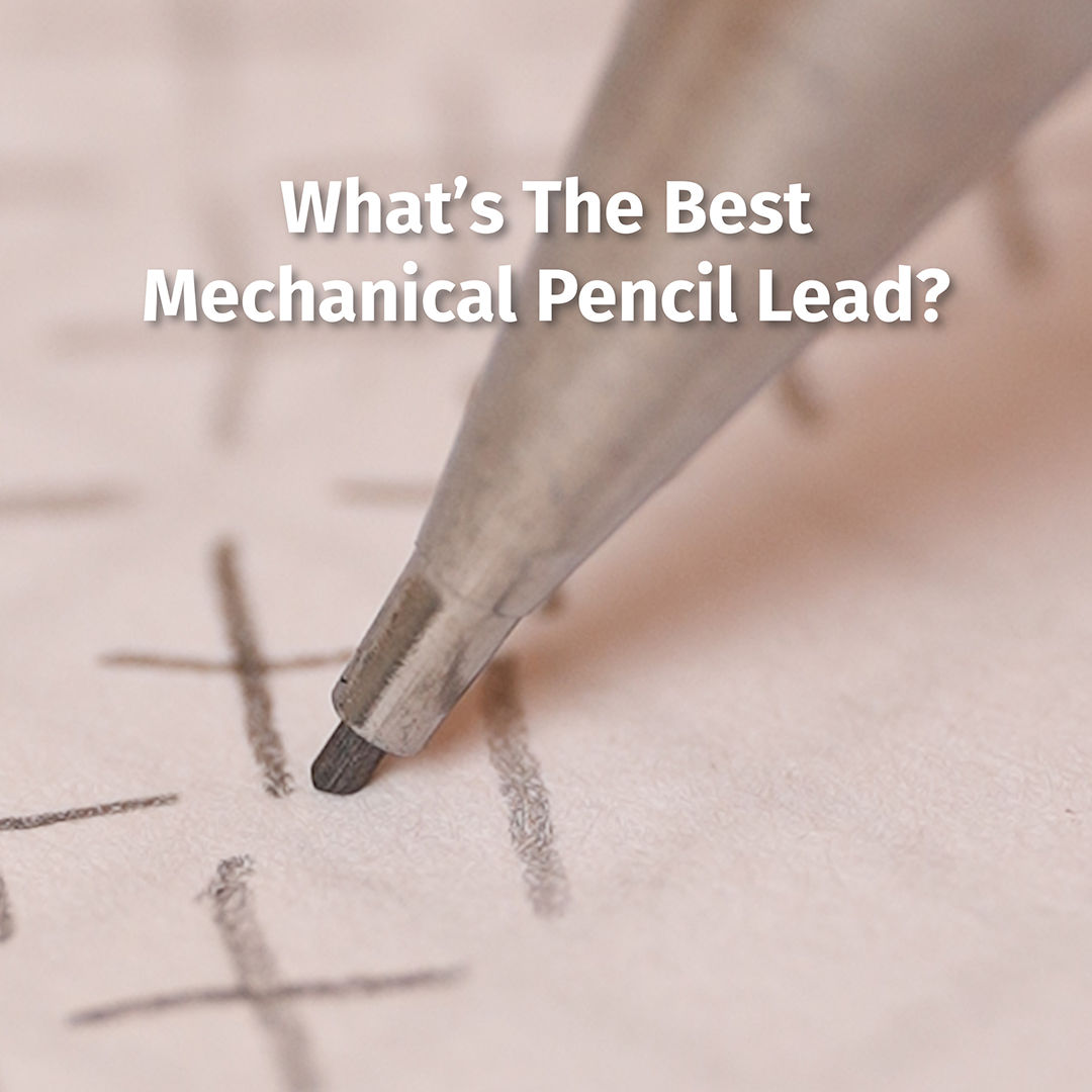 Close-up of a mechanical pencil tip shading an X in a tic-tac-toe grid on paper; overlaid text reads "What's The Best Mechanical Pencil Lead?"